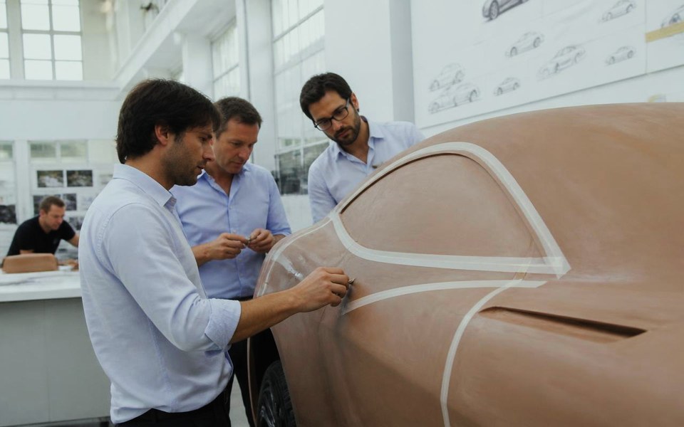 2018, German design studio, with the client atelier in Dubai: Designers finishing a full-size clay model of a high-performance coupé in a daylit German automotive design studio in 2018. — Avanti Holding, BLACK Automotive.